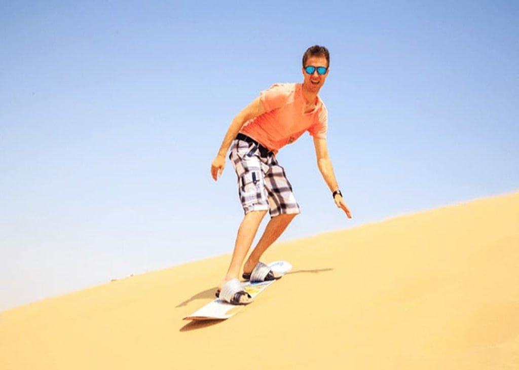 Sandboarding in Best Evening Desert Safari | Eagle Eyes Tourism