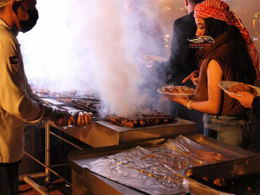 A female lady enquire about Live BBQ buffet dinner with arabic dress in Desert Safari Dubai